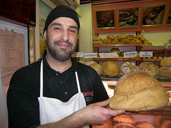Nunzio Martino, holding a loaf of the local bread, at his family's bakery in Matera, Italy.